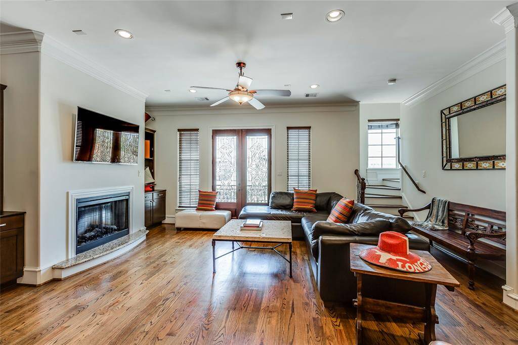 Beautiful Living Room with log fire, built-ins, hard wood floors, high ceiling & lead glass patio doors out to patio