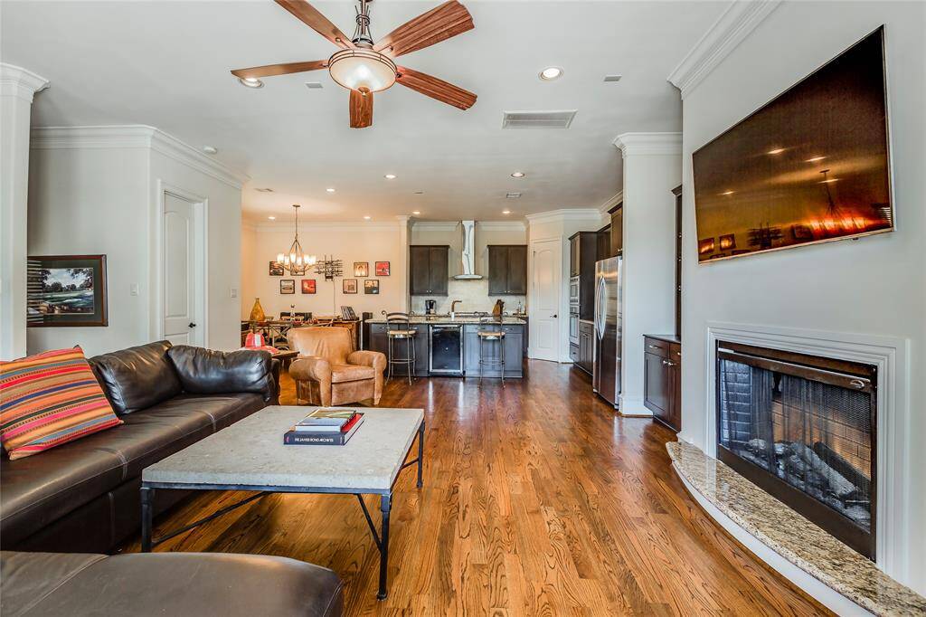 Beautiful Living Room with log fire, built-ins, hard wood floors, high ceiling & lead glass patio doors out to patio