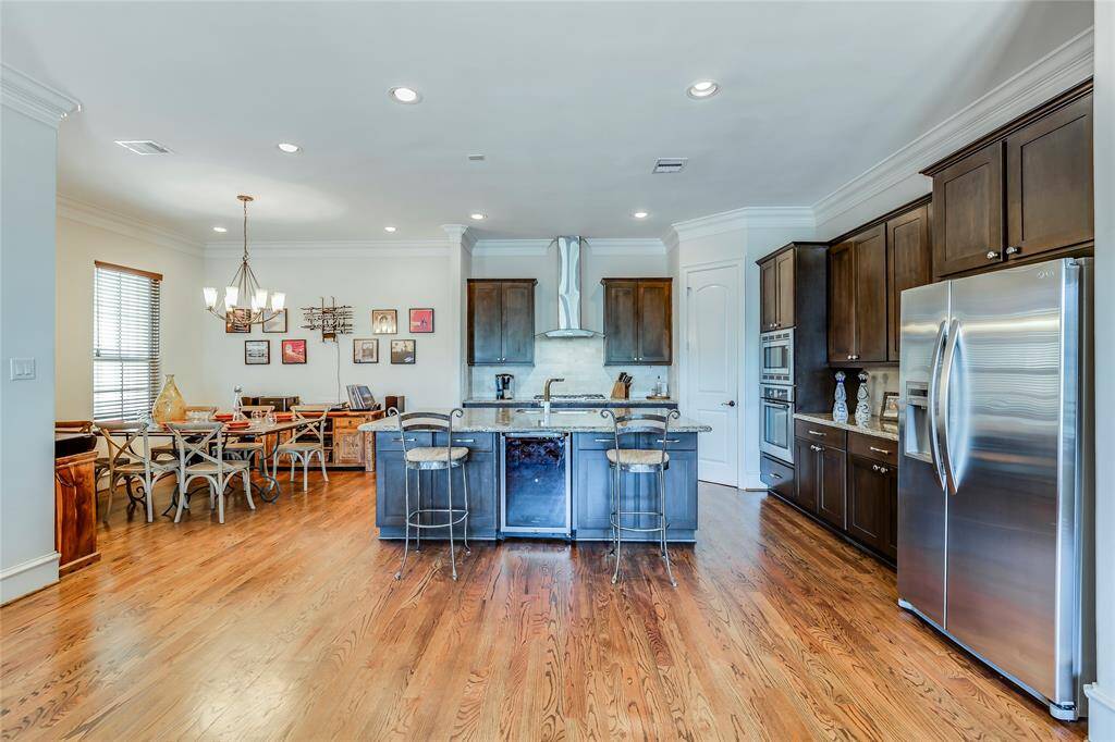 Beautiful Dining Room open to kitchen with wine fridge, SS appliances, lots of cabinets, pantry, hard wood floors