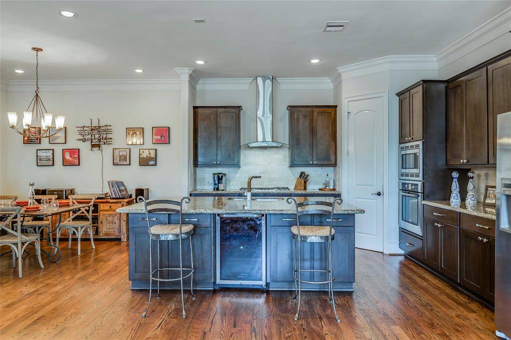 Beautiful Dining Room open to kitchen with wine fridge, SS appliances, lots of cabinets, pantry, hard wood floors