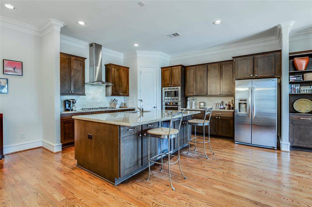 Beautiful large kitchen with wine fridge, SS appliances, lots of cabinets, pantry, granite counters, hard wood floors