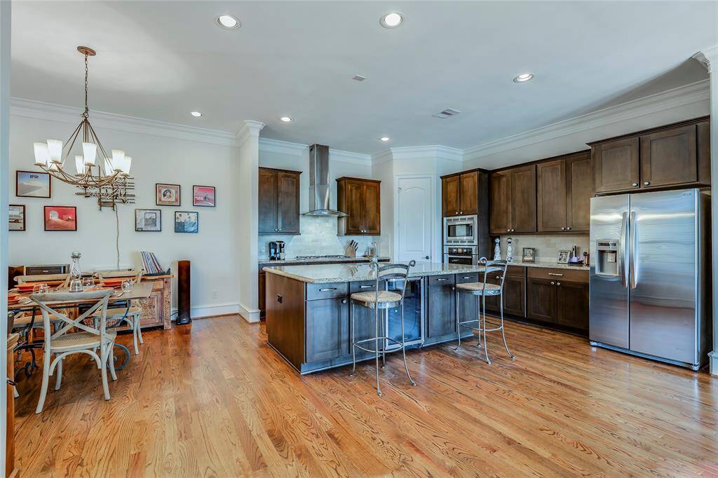 Beautiful large kitchen with wine fridge, SS appliances, lots of cabinets, pantry, granite counters, hard wood floors