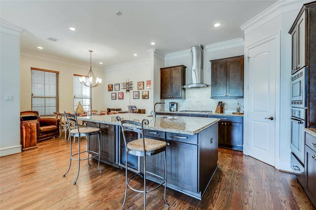 Beautiful large kitchen with wine fridge, SS appliances, lots of cabinets, pantry, granite counters, hard wood floors