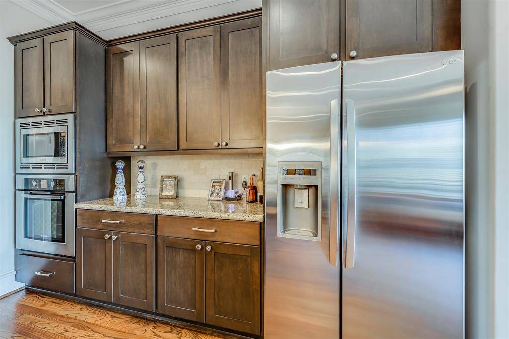 Beautiful large kitchen with wine fridge, SS appliances, lots of cabinets, pantry, granite counters, hard wood floors