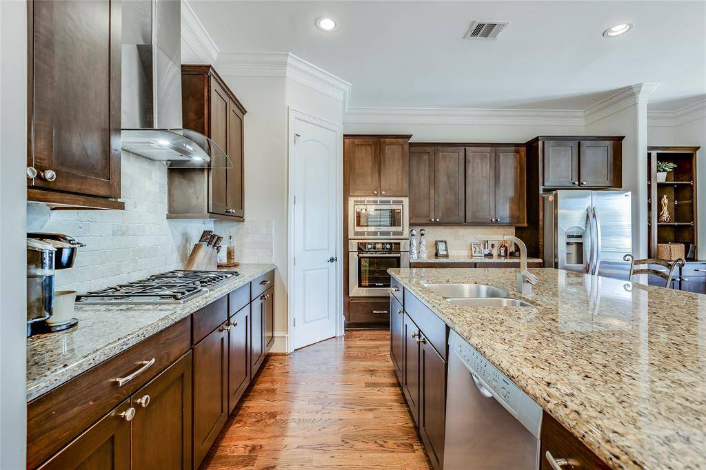Beautiful large kitchen with wine fridge, SS appliances, lots of cabinets, pantry, granite counters, hard wood floors