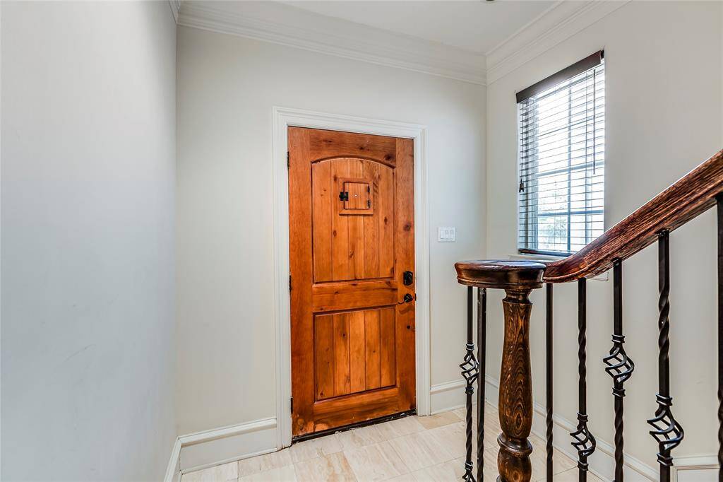 Entry with tile floors & wrought iron stair case - lots of natural light