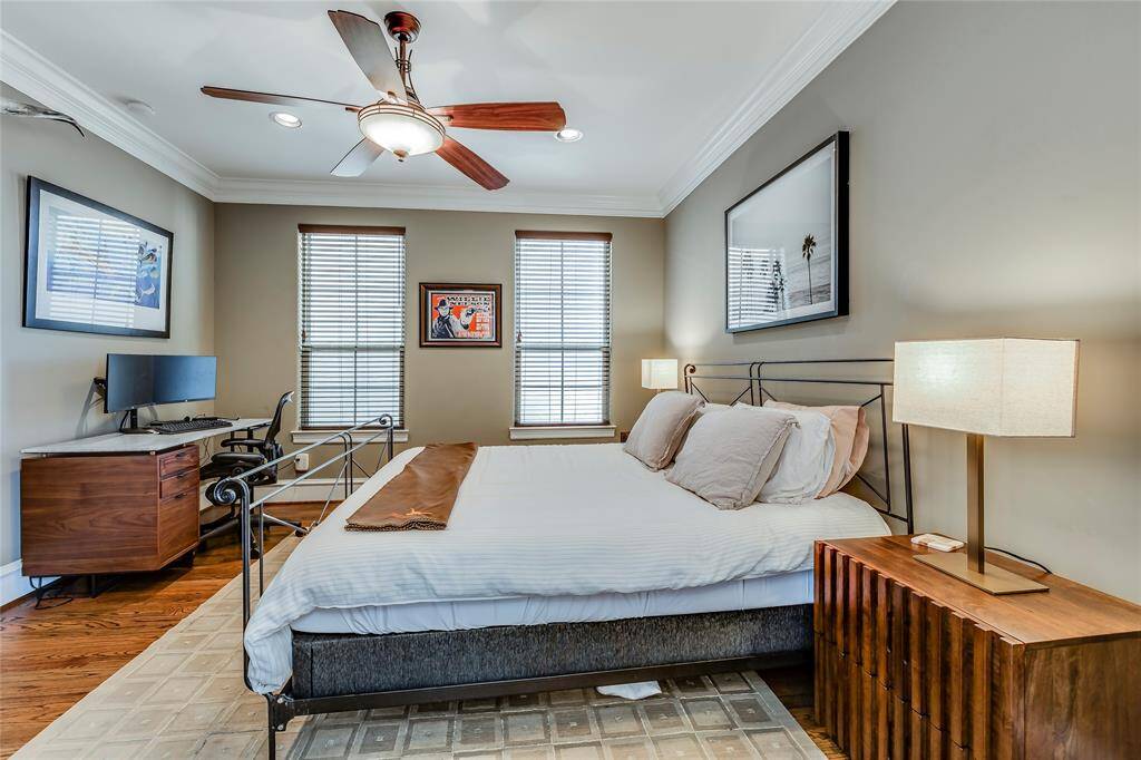 Large Primary bedroom with hardwood floors, ceiling fan, 2 inch blinds