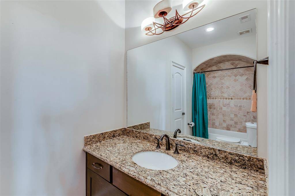 First floor bathroom with granite counters, under mounted sink, beautiful tile