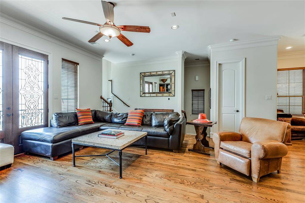 Open plan first floor living - high ceilings, hard wood floors, ciling fan, patio doors