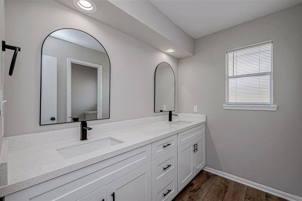 Secondary bathroom with two sinks.