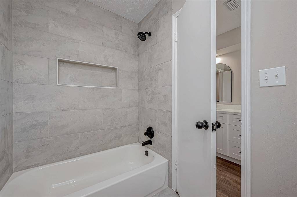 Shower tub combo in secondary bathroom.