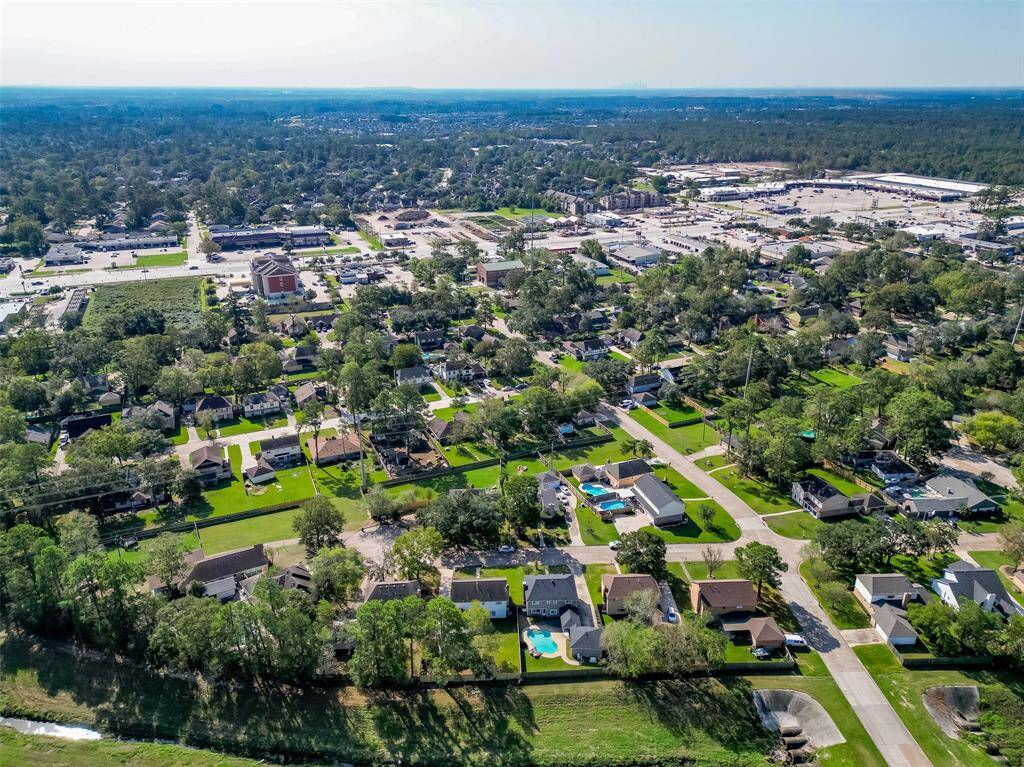 Beautiful aerial view of the area with mature trees and trails in the area.