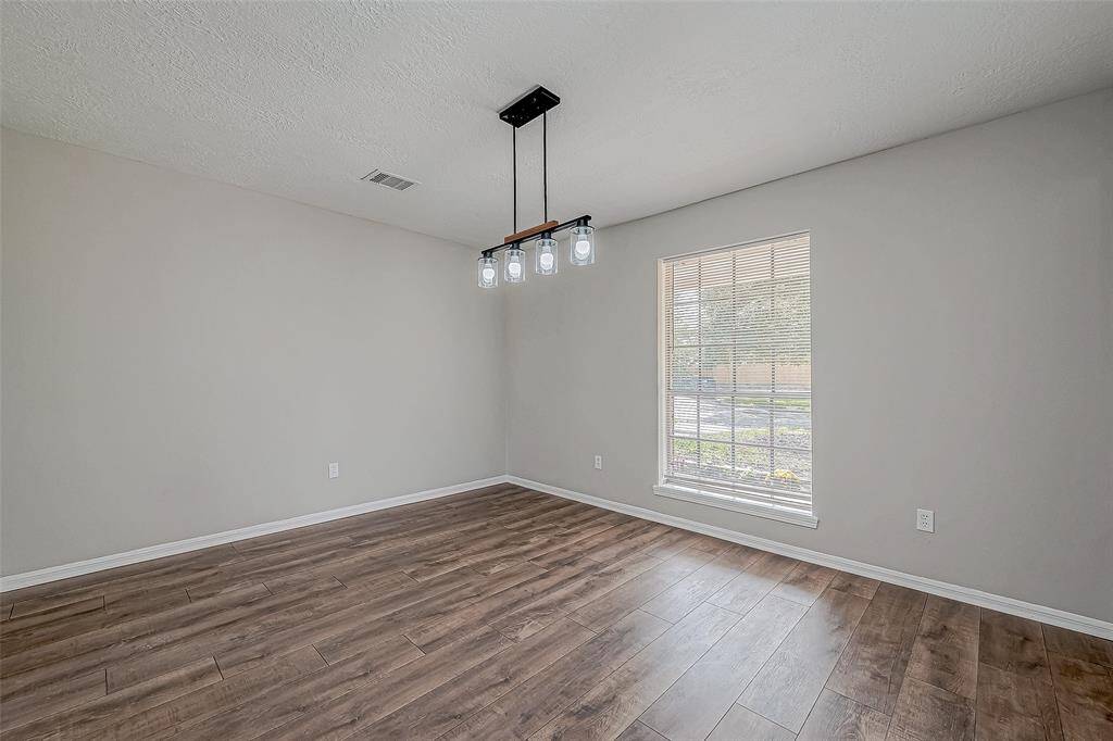 Formal dining room leading to the kitchen.