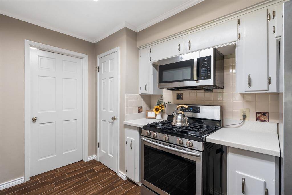The pantry is located in the door on the right. Your home chef will enjoy cooking on the stainless steel gas cooktop.