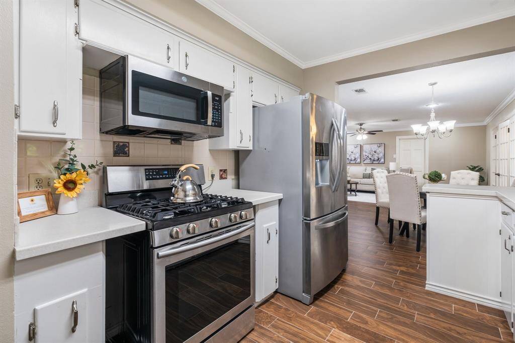 Another view of the galley style kitchen.  The wood look tile flows perfectly into the breakfast room, family room, and the game room.