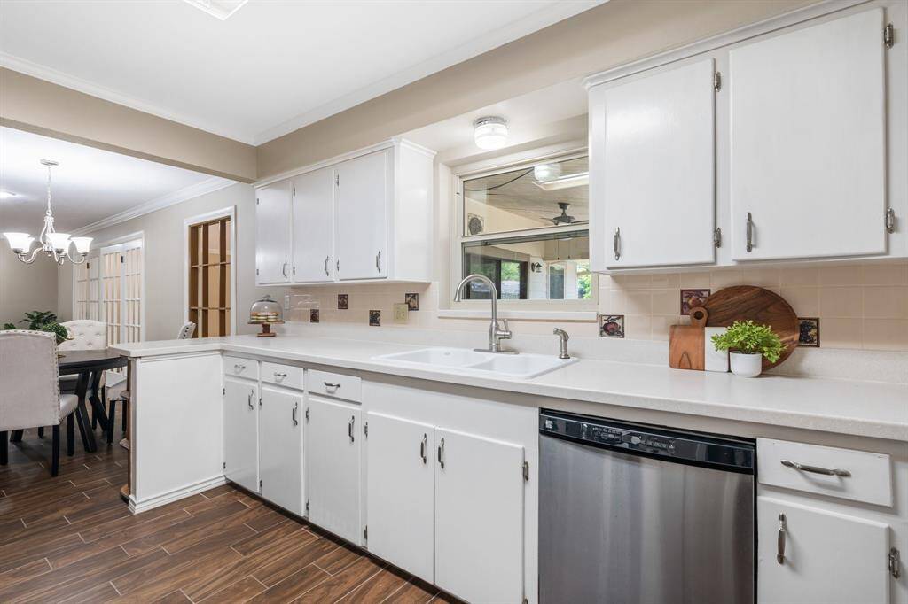 The kitchen features stainless steel appliances.  Window looks out to the covered porch.