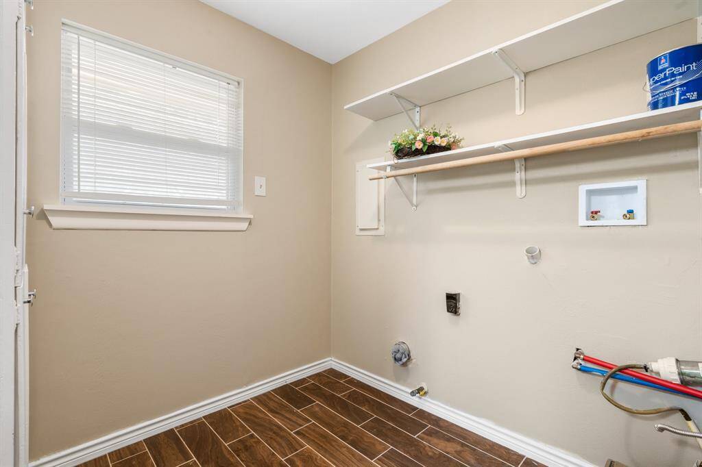 Utility room is located off the garage.  There's built-in shelving, and cabinets to store all of your things.