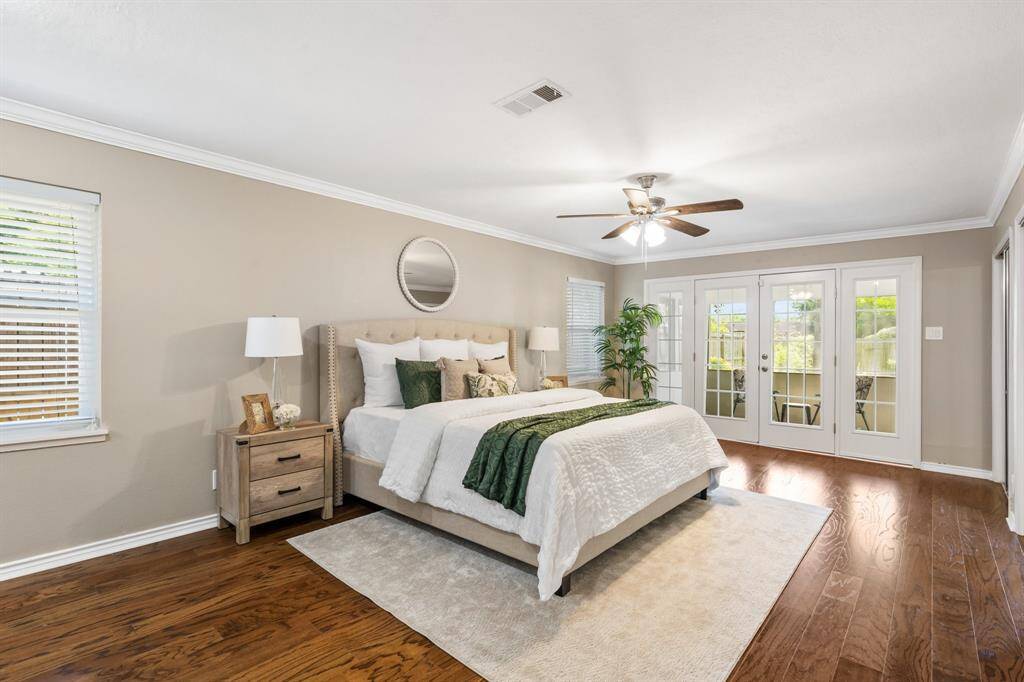 Primary suite with hardwood floors, windows and elegant french doors provide a great deal of natural light. The french doors lead to your private screened-in porch that overlooks the backyard. This would be a great place to relax and read a book.