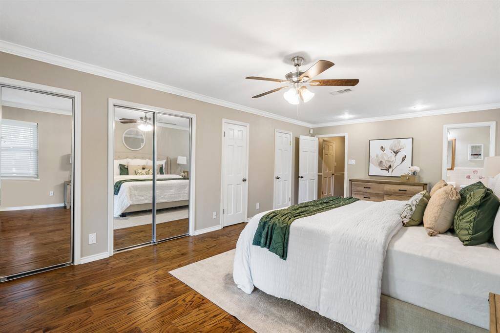 Another view of the primary suite  with dual closets.  Open door leads into the hallway.