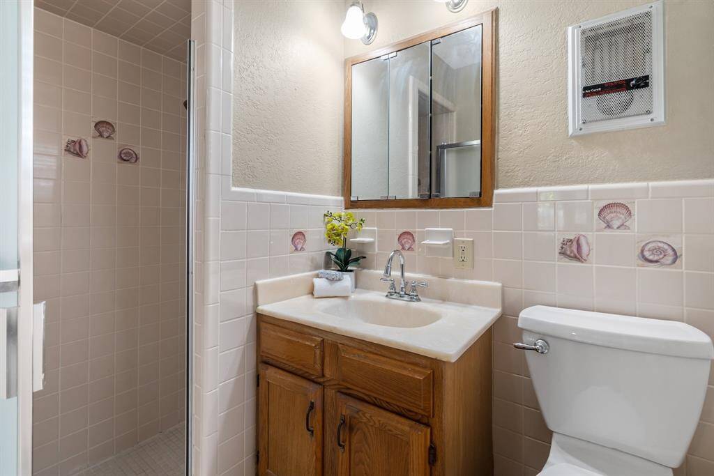 Primary bathroom has a single sink and shower.