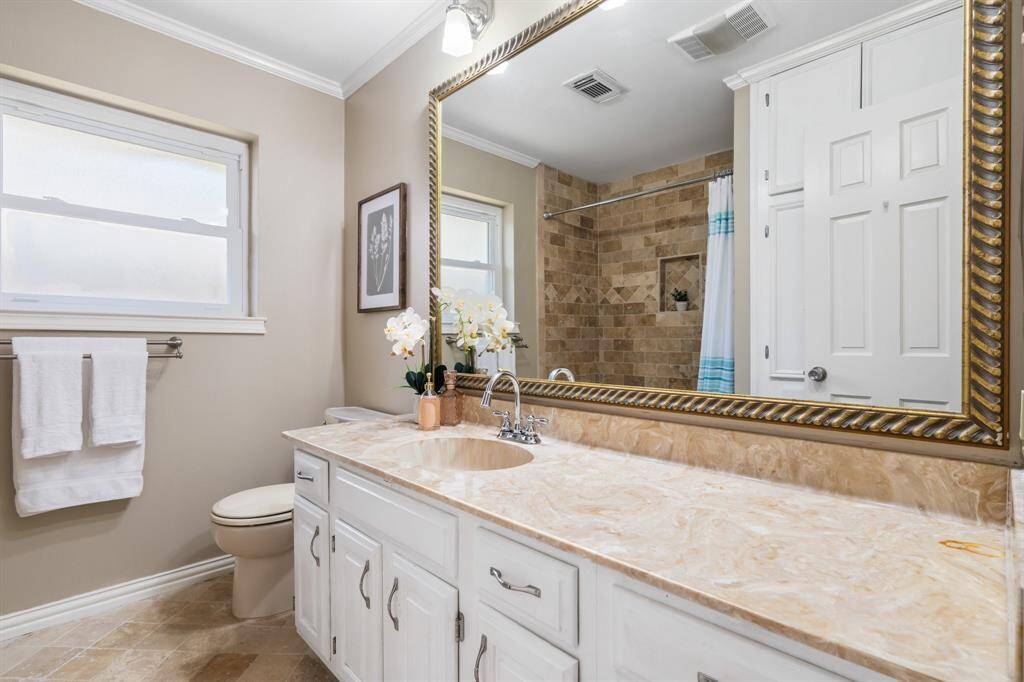 Bathroom has cabinets for storing all of your bathroom items.  Large vanity area, sink, and tub with shower combo.