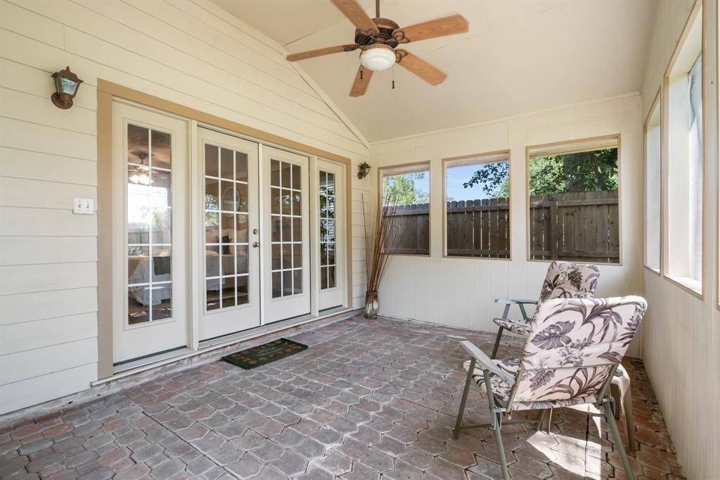 Covered porch with ceiling fan provides private access to the primary suite.