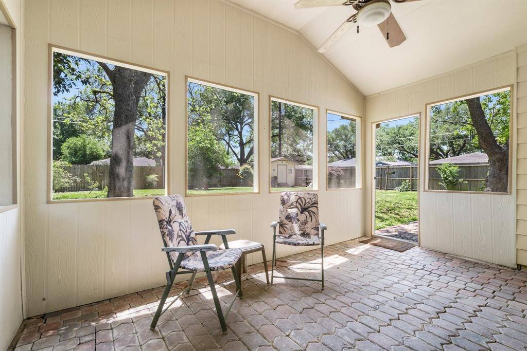 Screened in porch looking into the backyard.