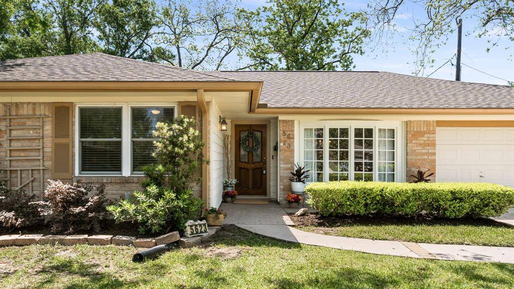 The beautiful front door and bay window are inviting for your guests when they arrive to visit.