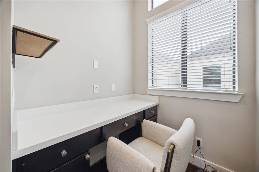 Off the kitchen, you’ll find the perfect home office area with large windows, a custom built-in desk and a quartz countertop.