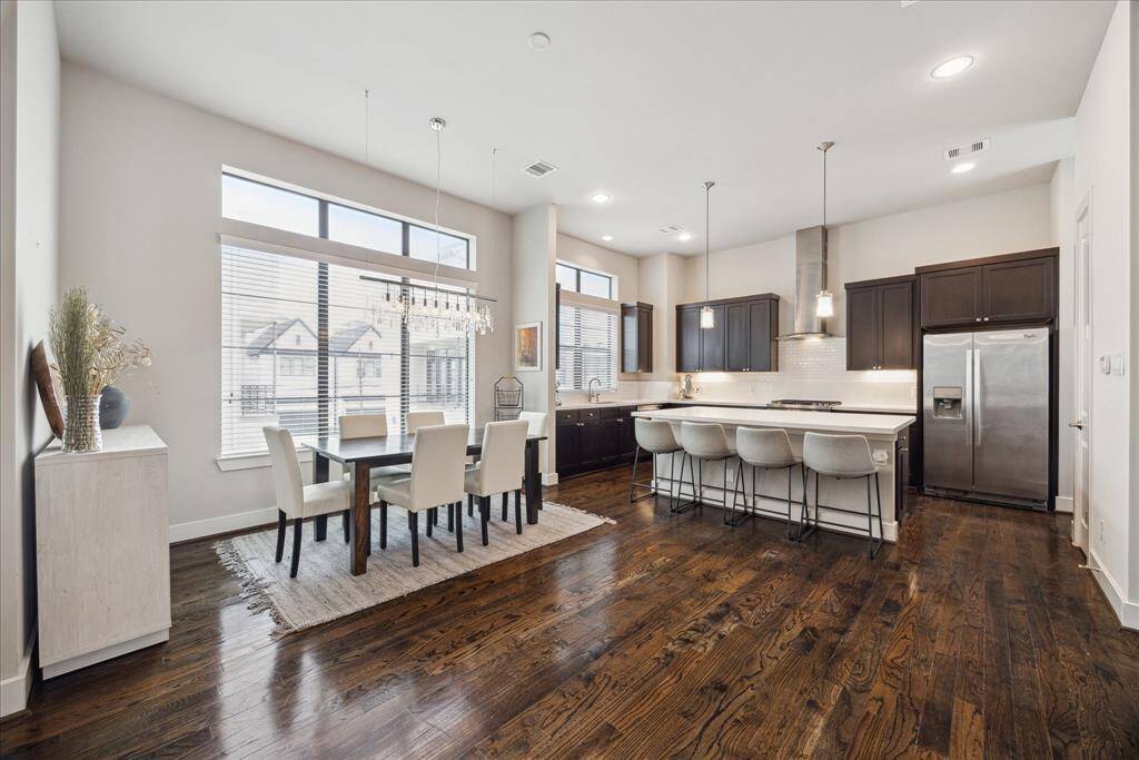 Plan your next dinner party in the spacious dining area topped with a lovely chandelier, or enjoy casual meals at the massive island/breakfast bar.