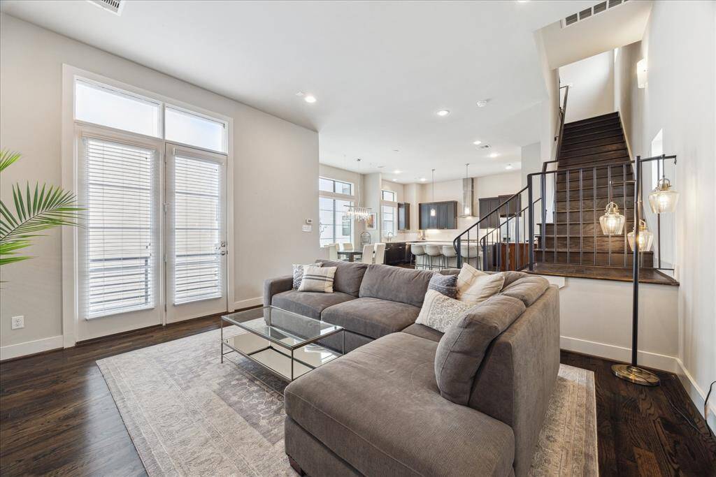 French doors topped by transom windows open to the large balcony, the perfect destination for morning coffee and after-dinner drinks.