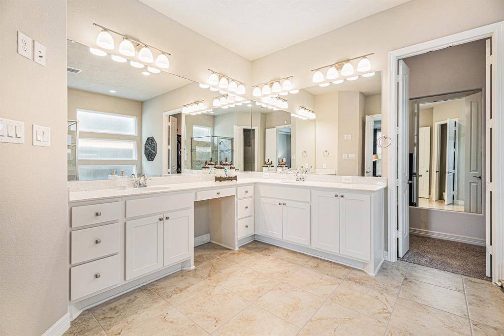 Primary Bathroom with vanity, his & her sinks, garden tub & seperate dhower