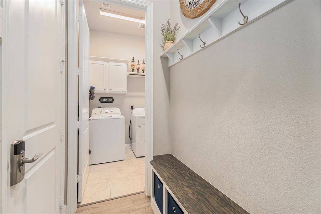 Laundry room and garage entry catch all area with storage & hooks