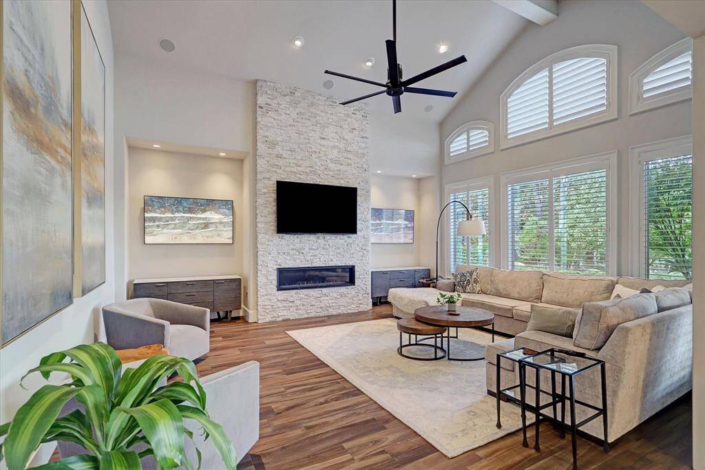 The family room is the heart of the home, soaring ceilings, lake views, and multiple TVs make it the perfect spot for endless family fun and togetherness.