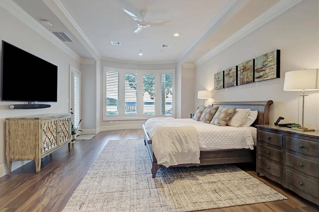 The primary suite offers direct access to the pool area, creating a true private retreat just steps from the water.