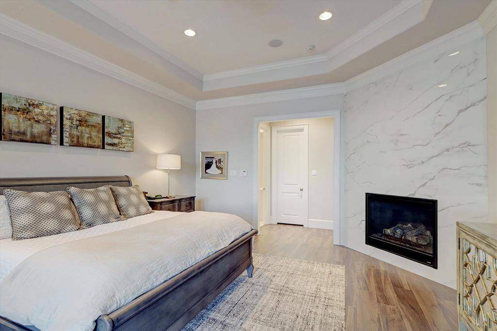 The primary suite features a fireplace, perfect for relaxing on chilly nights with warmth and style.