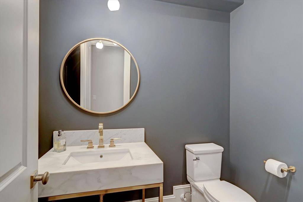 The chic first-floor powder room is just steps away from the main living areas.
