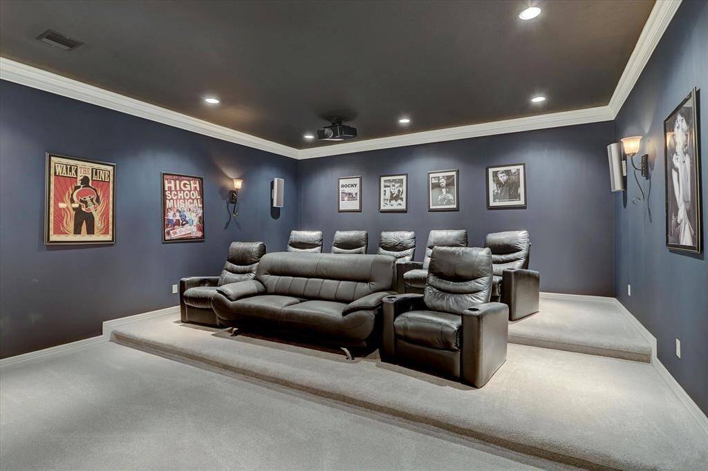The perfect spot for movie nights, this media room comes complete with plush seating, a high-quality projector, and a large screen for an immersive cinematic experience.