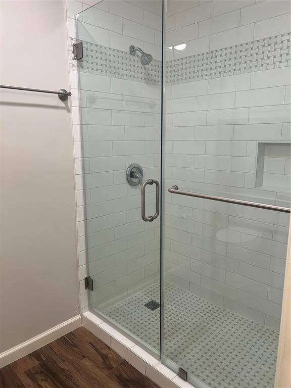 Primary bathroom features oversized tiled shower.