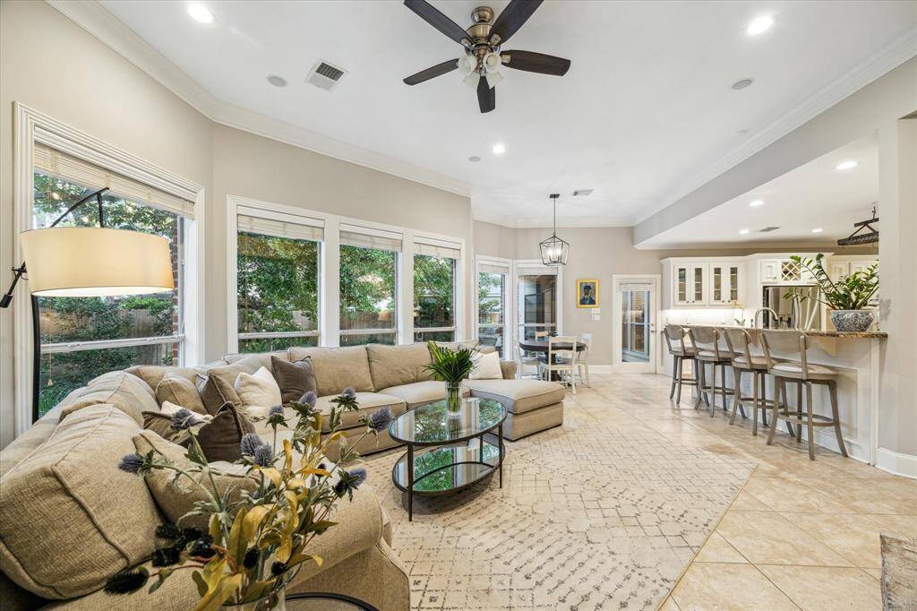 Beautiful tile floors connect the living and dining spaces along with an extended dine-in breakfast bar in the kitchen.