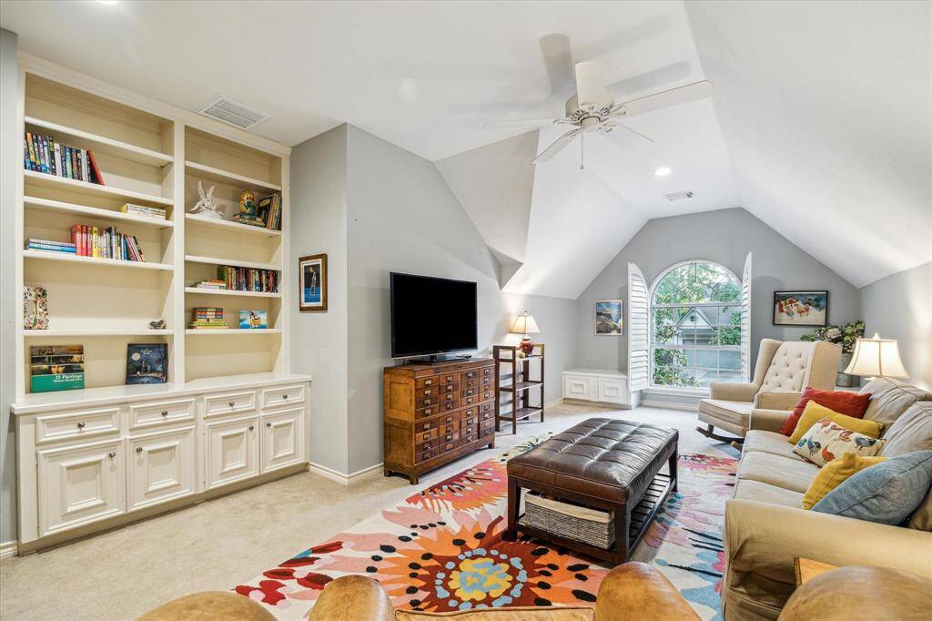 Everyone loves this welcoming and fun family room perfectly designed for a cozy couch with custom shelves and lots of space to unwind.