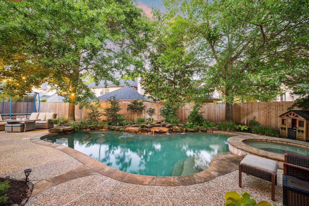 The outdoor pool with jacuzzi is an absolutely-coveted private backyard escape.