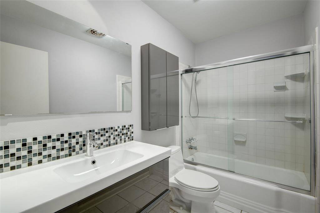 Bathroom has a tiled tub shower combo for the best of both worlds