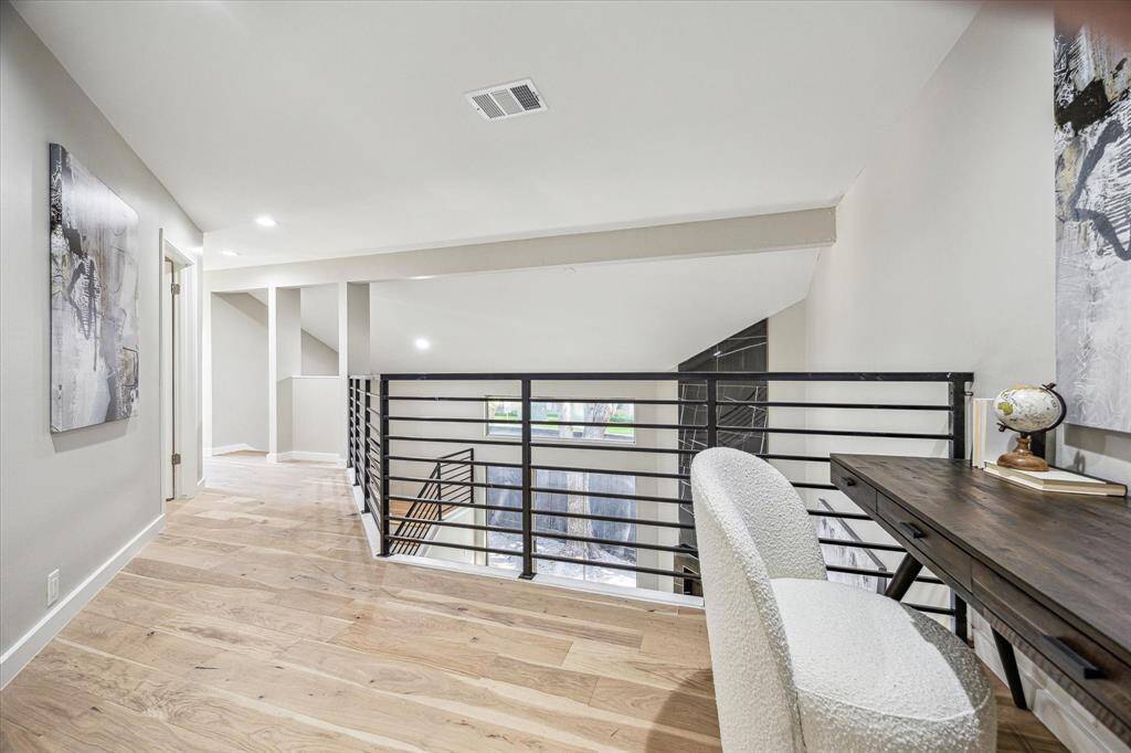 The loft/bonus area offers the perfect nook for a quiet sitting area, treadmill/Peloton or home office, with outstanding views of the living room and private patio below.