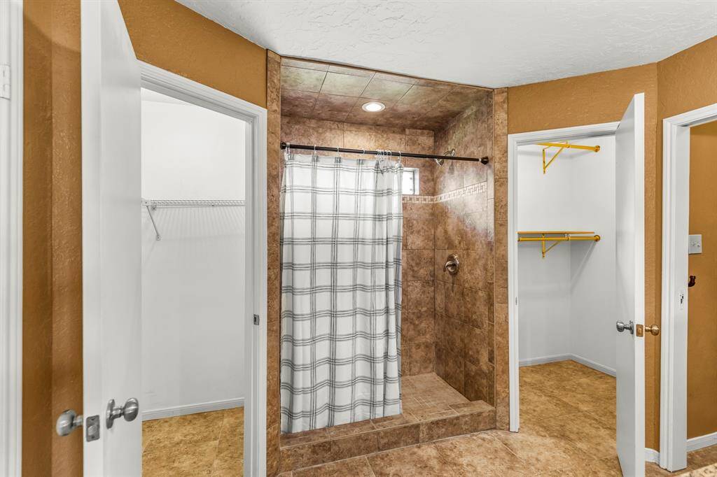 The master bathroom walk in shower and walk-in closets