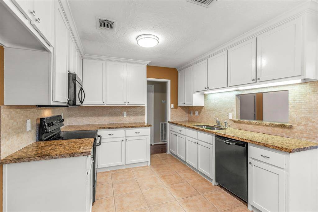 The kitchen also has a pass through window with granite counter top that opens to the dining area, built in dishwasher, updated lighting and tile flooring