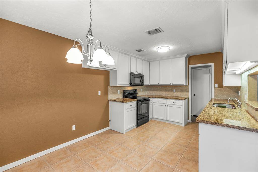 The breakfast area is large and bright, with updated lighting and room for a table and chairs