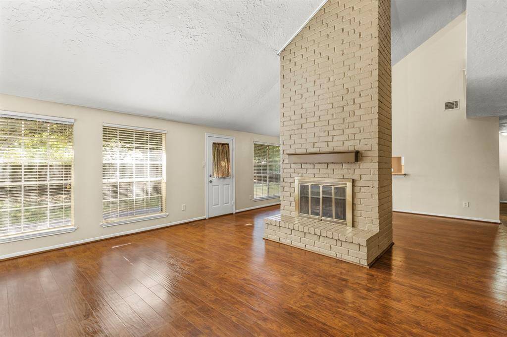 The living room is spacious and opens to the back yard with large windows to let in the light.  The dining room is adjacent and convenient to the living room.