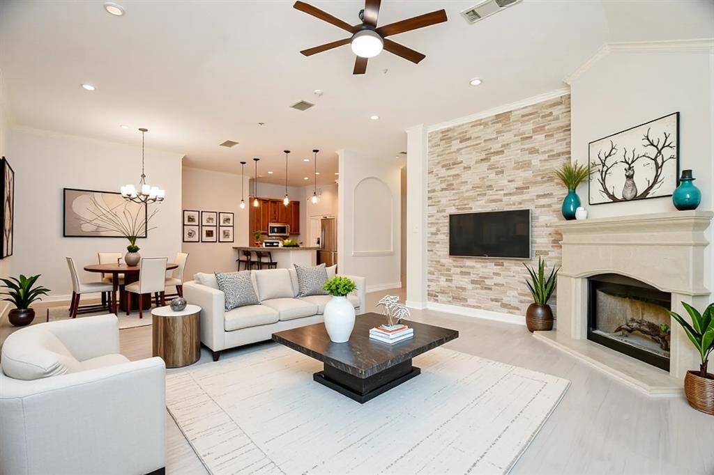 Spacious living room with beautiful stone accent wall and fireplace.  (This photo has been virtually staged)