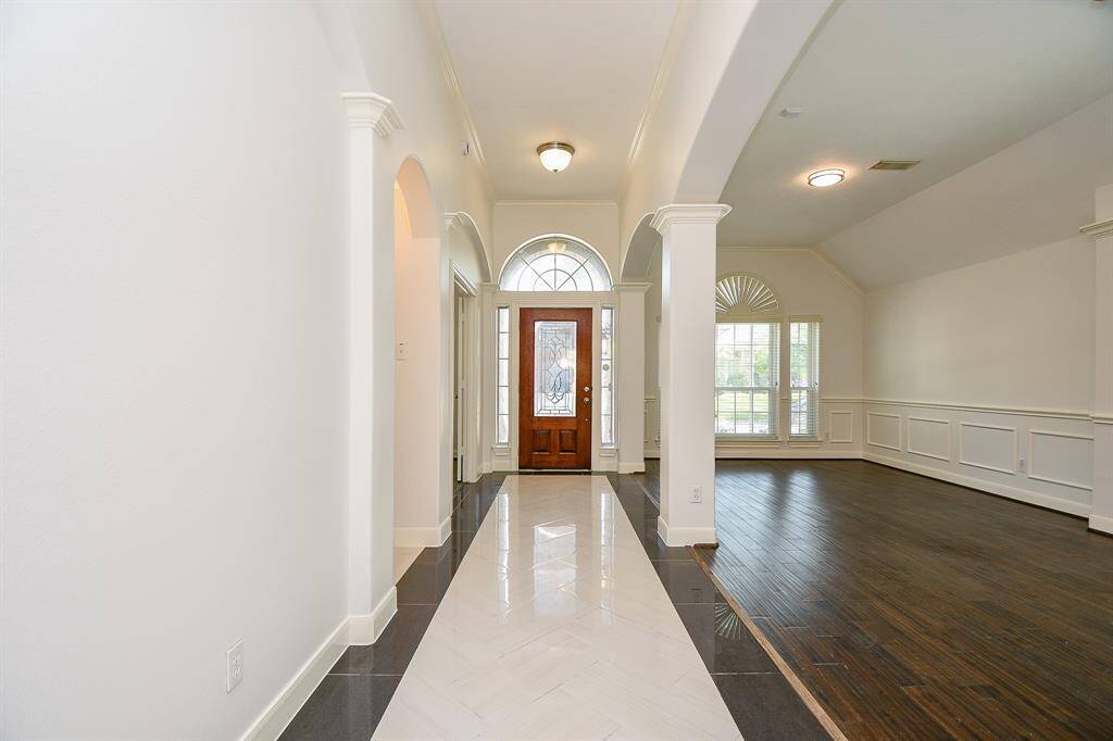 Open great room with newly refinished wood floors
